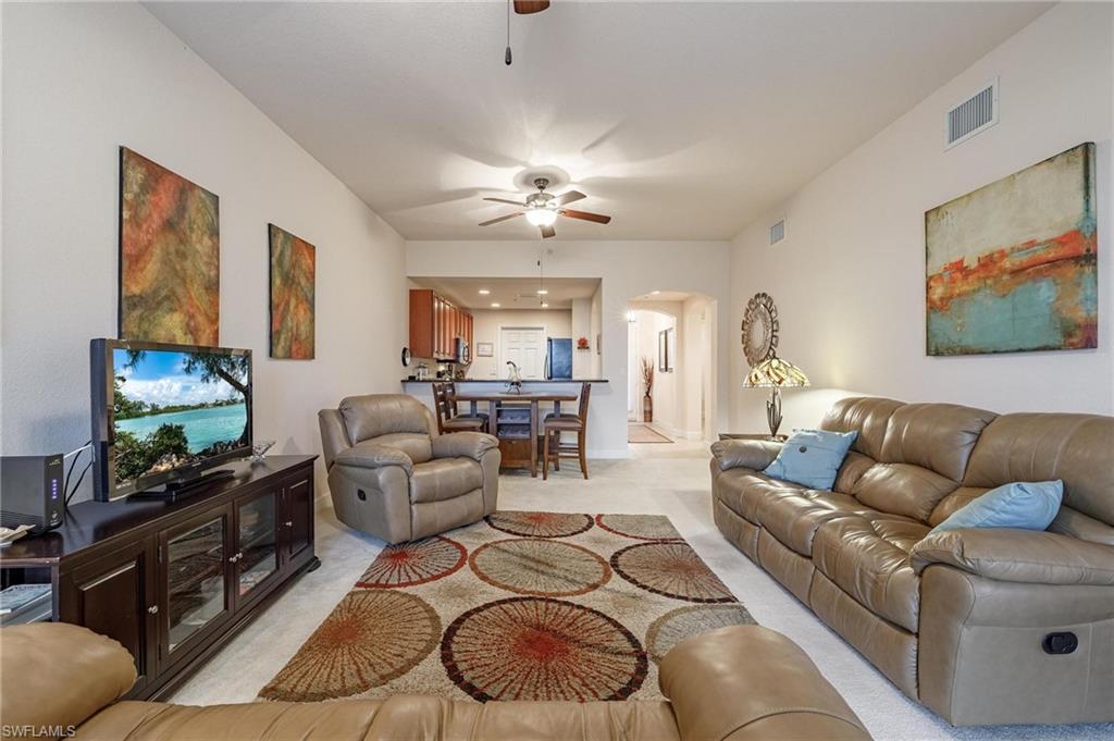 17298 Acapulco Road, Unit 512 Punta Gorda, FL 33955 - Photo 13 of 34 a living room with furniture and a flat screen tv