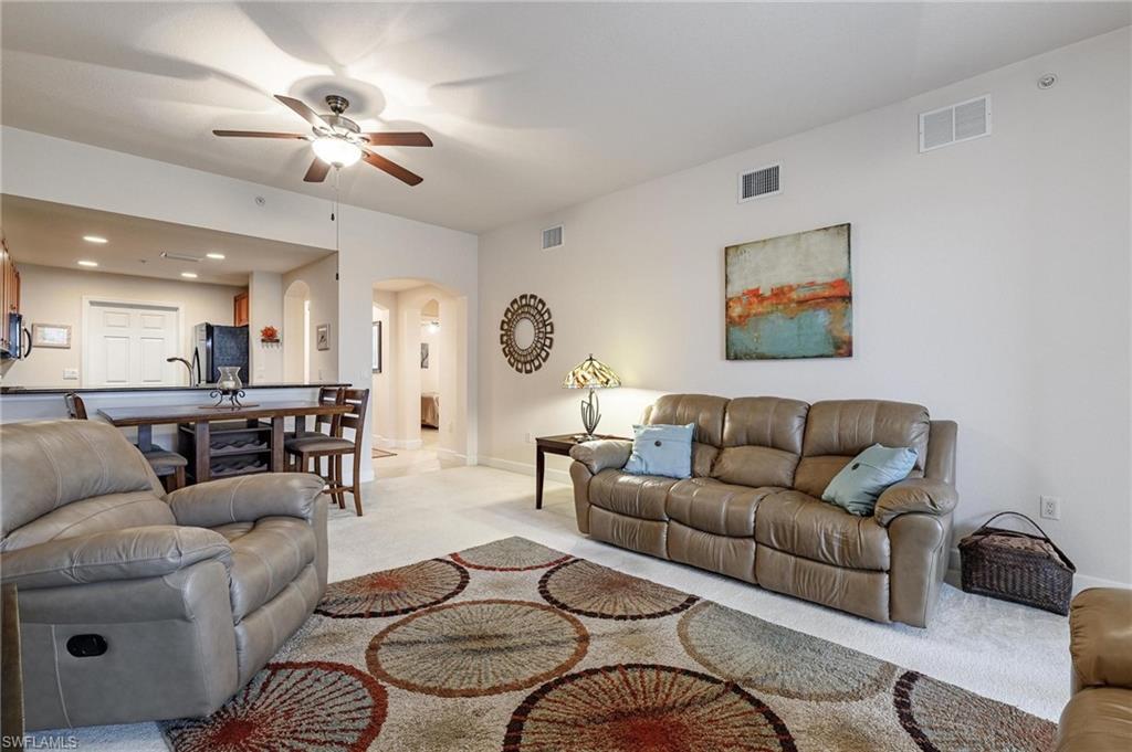 17298 Acapulco Road, Unit 512 Punta Gorda, FL 33955 - Photo 14 of 34 a living room with furniture kitchen view and a chandelier