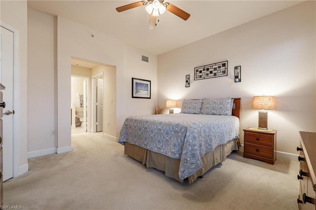 17298 Acapulco Road, Unit 512 Punta Gorda, FL 33955 - Photo 17 of 34 a spacious bedroom with a bed and a chandelier
