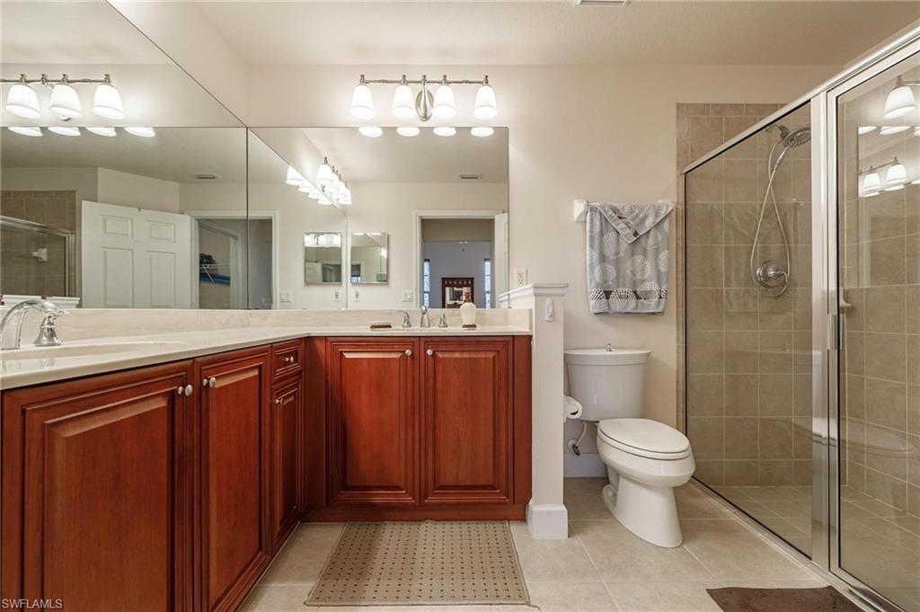 17298 Acapulco Road, Unit 512 Punta Gorda, FL 33955 - Photo 19 of 34 a bathroom with a sink a toilet a mirror and shower