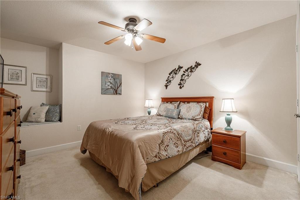 17298 Acapulco Road, Unit 512 Punta Gorda, FL 33955 - Photo 21 of 34 a bedroom with a bed and a chandelier