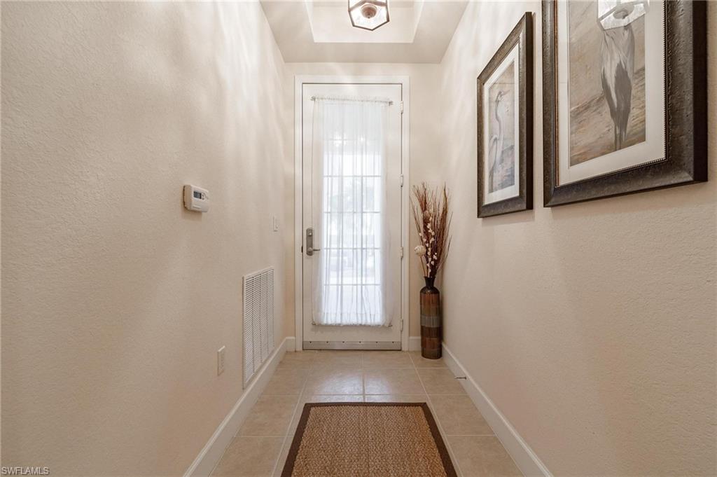 17298 Acapulco Road, Unit 512 Punta Gorda, FL 33955 - Photo 3 of 34 a view of a hallway with wooden floor and a window