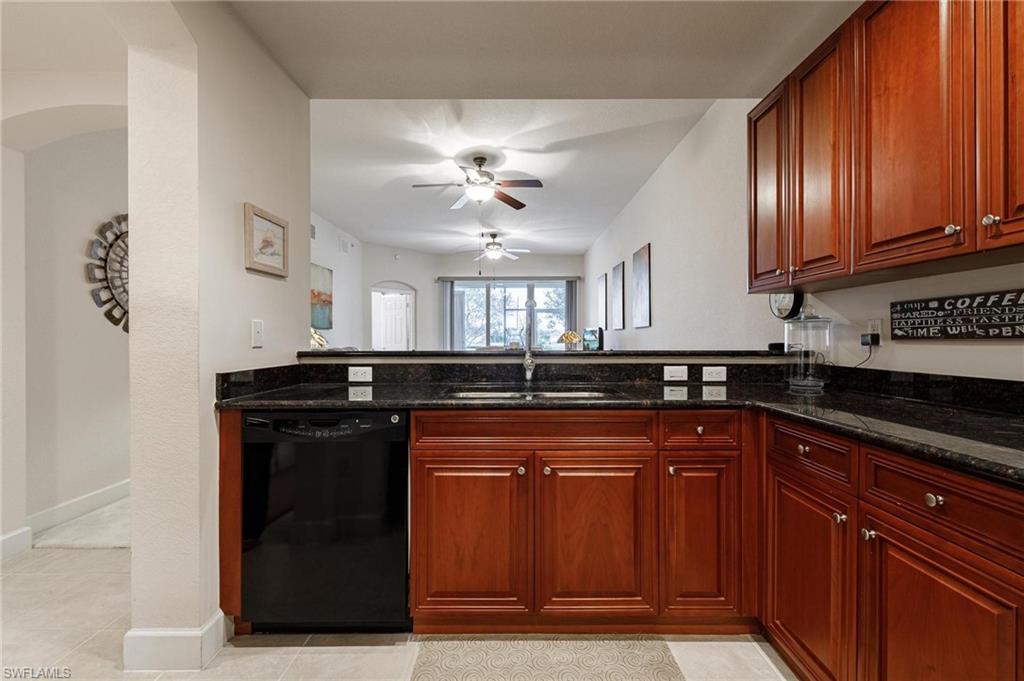 17298 Acapulco Road, Unit 512 Punta Gorda, FL 33955 - Photo 6 of 34 a kitchen with stainless steel appliances granite countertop a sink stove and cabinets