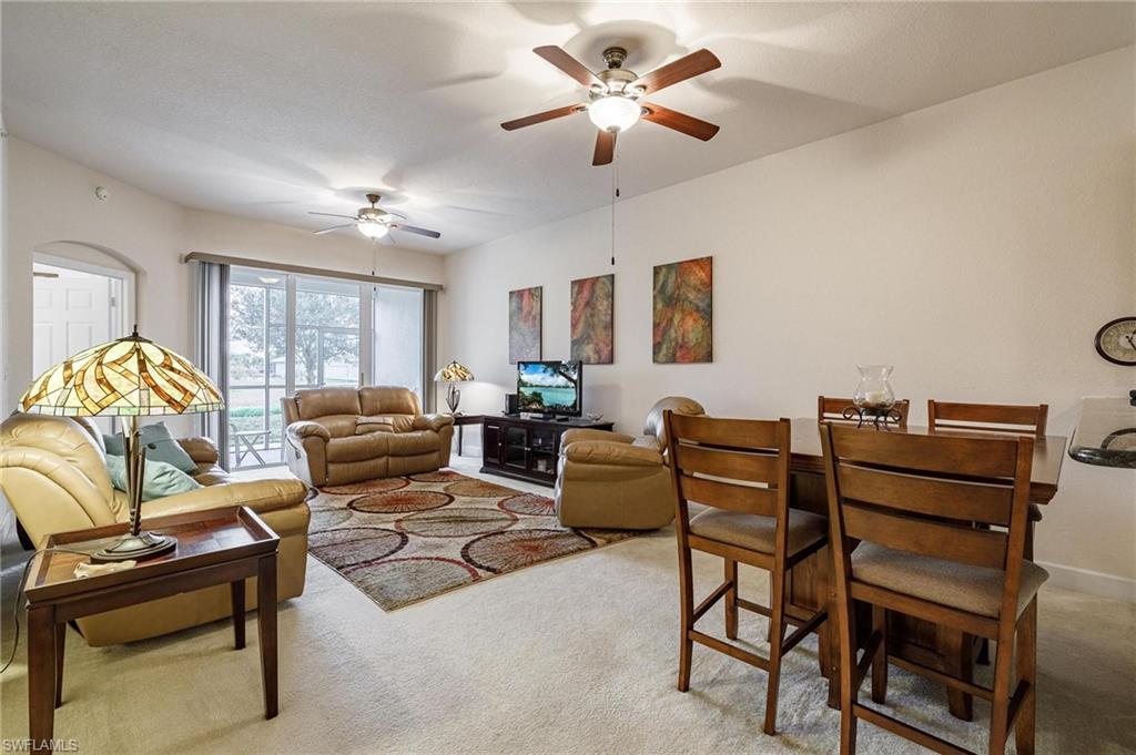 17298 Acapulco Road, Unit 512 Punta Gorda, FL 33955 - Photo 10 of 34 a living room with furniture a ceiling fan and a rug