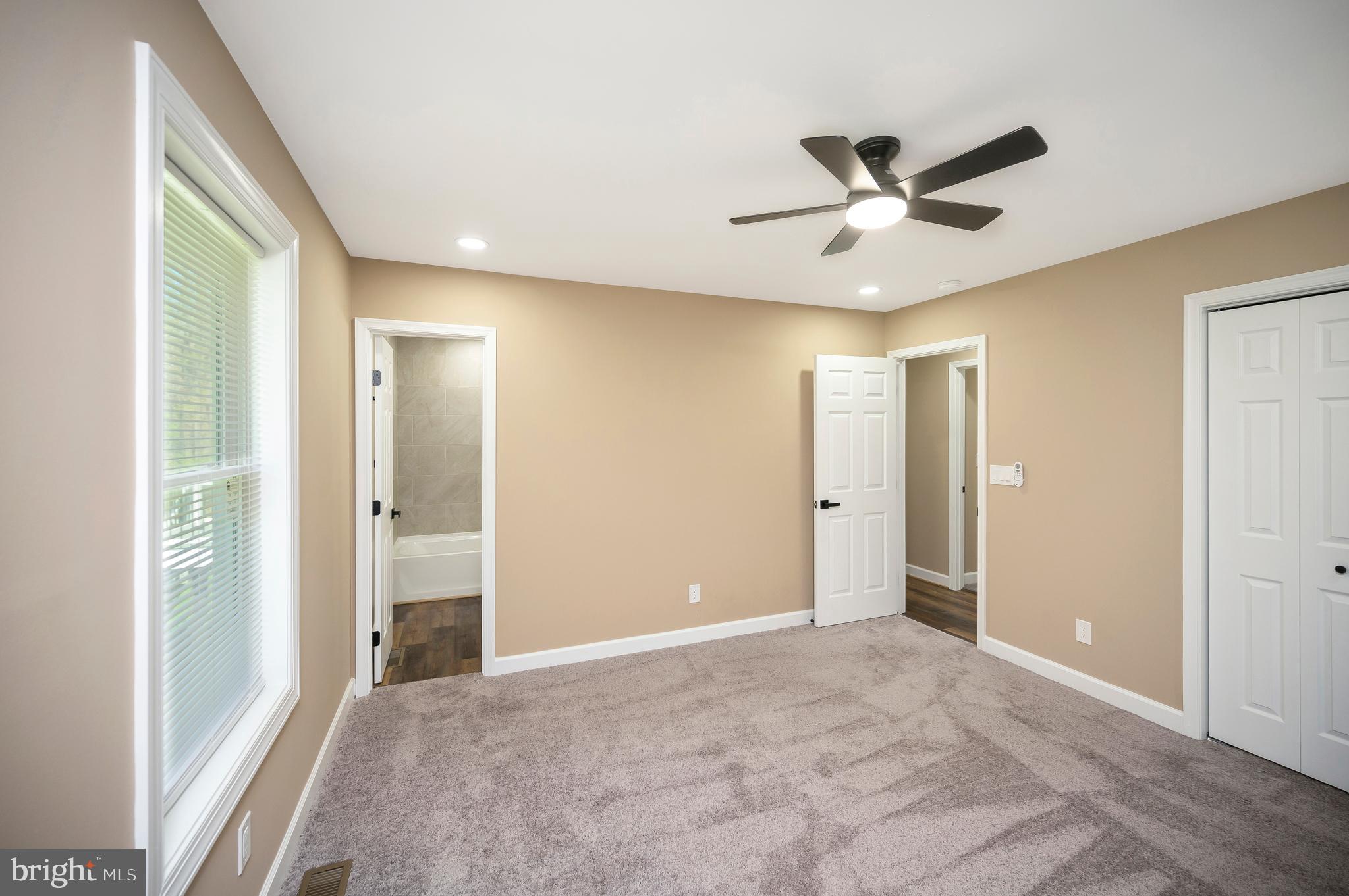 13452 Post Oak Road Spotsylvania, VA 22551 - Photo 33 of 56 a view of a livingroom with a ceiling fan & entryway