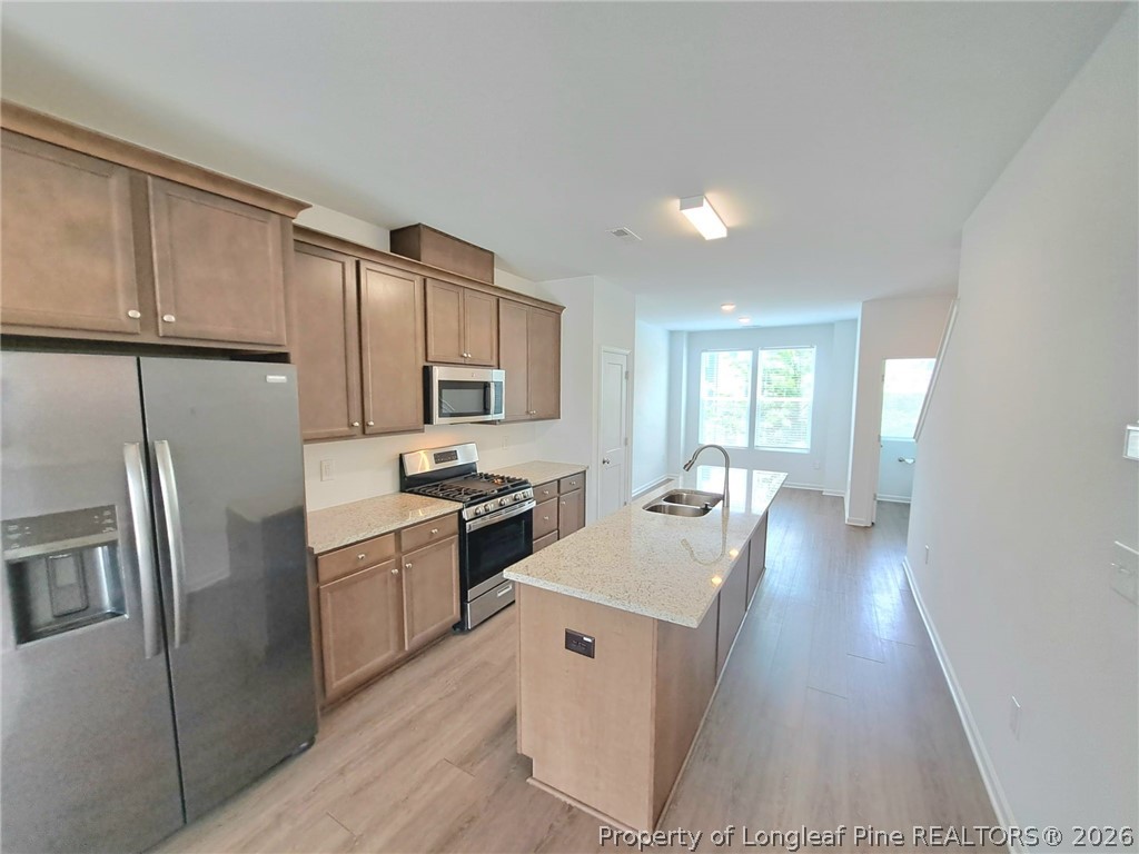 1939 Robin Hill Lane Raleigh, NC 27610 - Photo 8 of 25 a kitchen with white cabinets and stainless steel appliances
