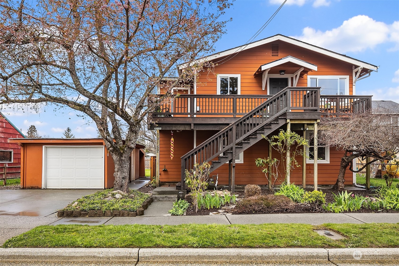 a front view of a house with a garden