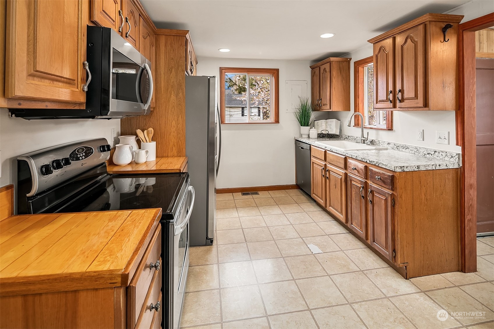 39152 Southeast Delta Street Snoqualmie, WA 98065 - Photo 11 of 26 a kitchen with stainless steel appliances granite countertop a stove a sink and a microwave