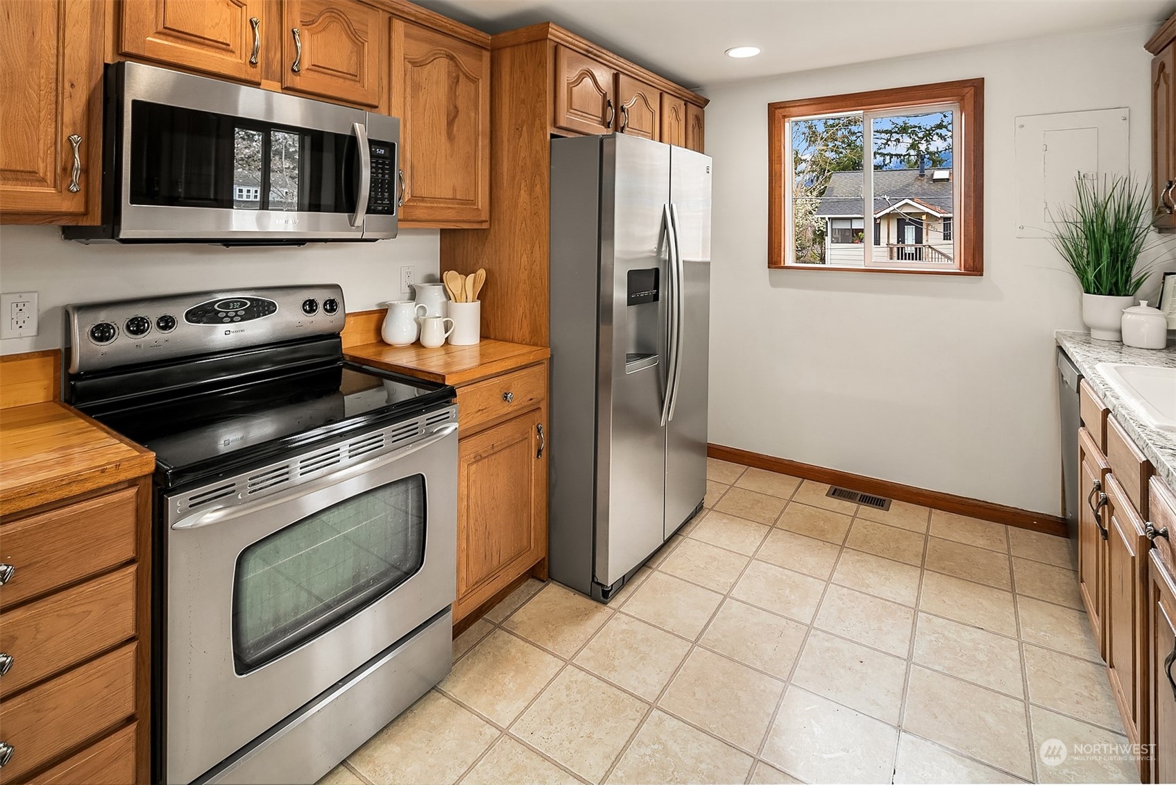 39152 Southeast Delta Street Snoqualmie, WA 98065 - Photo 13 of 26 a kitchen with stainless steel appliances a stove a microwave and a refrigerator