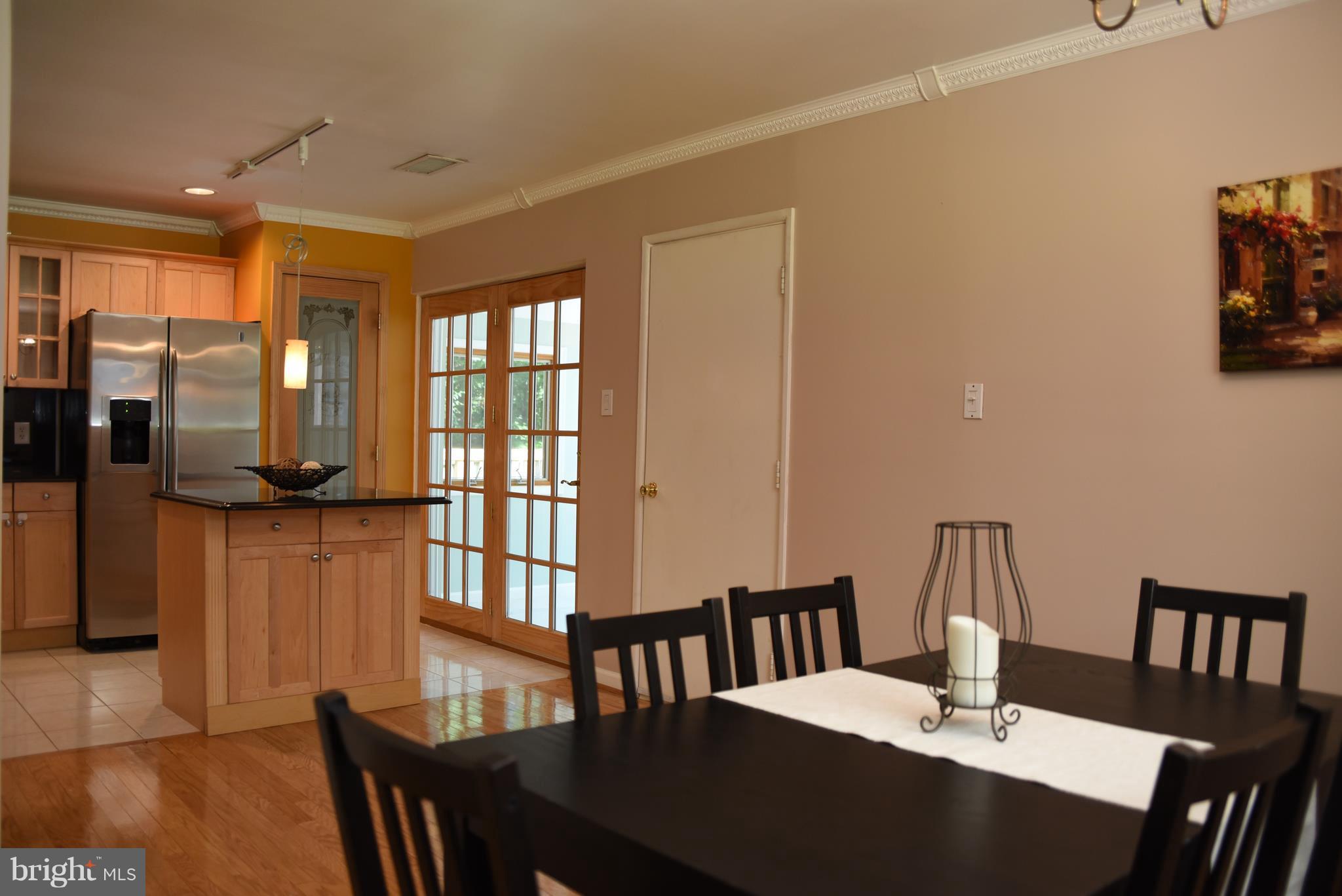 8911 Victoria Road Springfield, VA 22151 - Photo 7 of 22 a view of a dining room with furniture and a potted plant