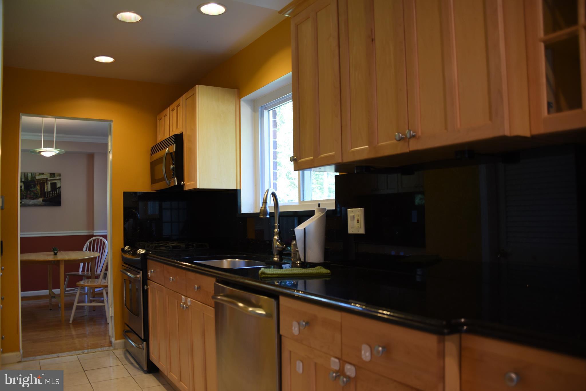 8911 Victoria Road Springfield, VA 22151 - Photo 8 of 22 a kitchen with a sink and cabinets