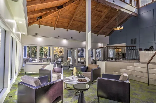 a living room with furniture and a dining table