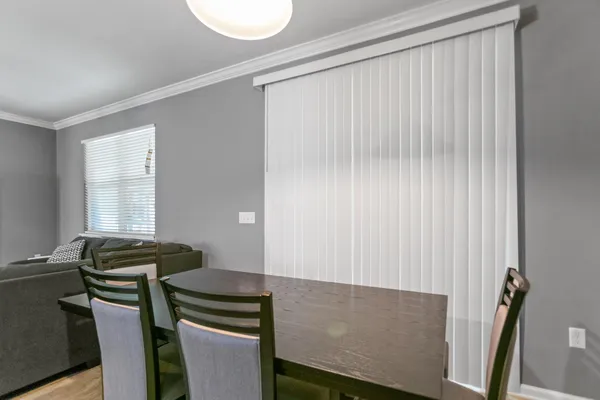 a view of a dining room with furniture wooden floor and chandelier