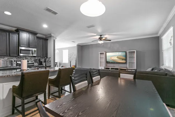 a spacious bedroom with a bed and a chandelier