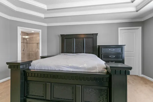 a bedroom with a bed and a chandelier