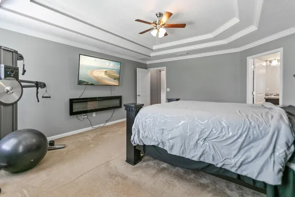 a bedroom with a bed and a chandelier