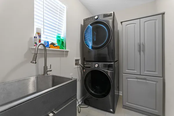 a view of an empty room with wooden floor and a balcony