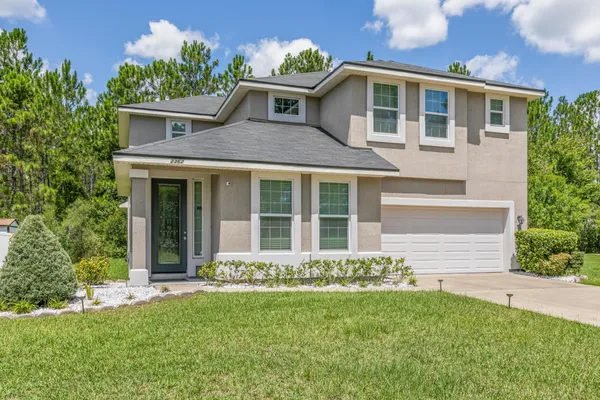 a front view of a house with a yard