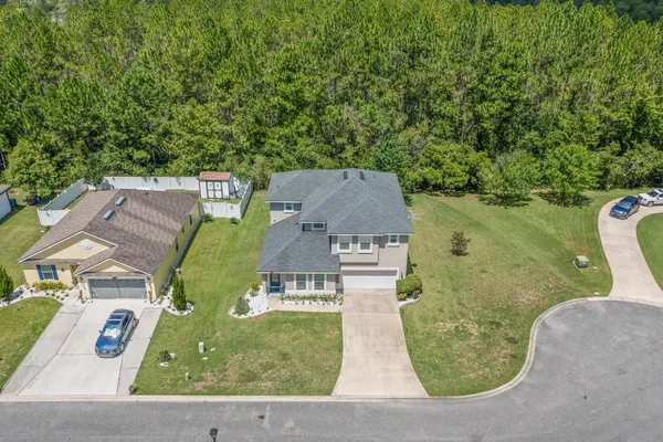an aerial view of a house with a yard