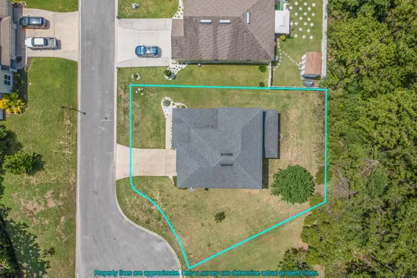 an aerial view of a house with swimming pool and garden