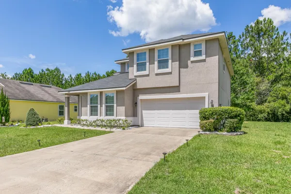 a front view of a house with a yard
