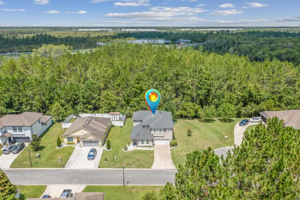 a view of a house with a backyard patio and swimming pool