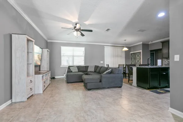 a living room with furniture and a chandelier