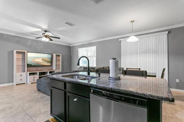 a kitchen with stainless steel appliances granite countertop a stove refrigerator and cabinets