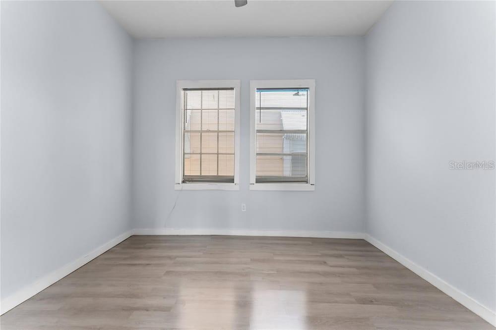 2320 West Walnut Street Tampa, FL 33607 - Photo 12 of 19 an empty room with wooden floor and windows