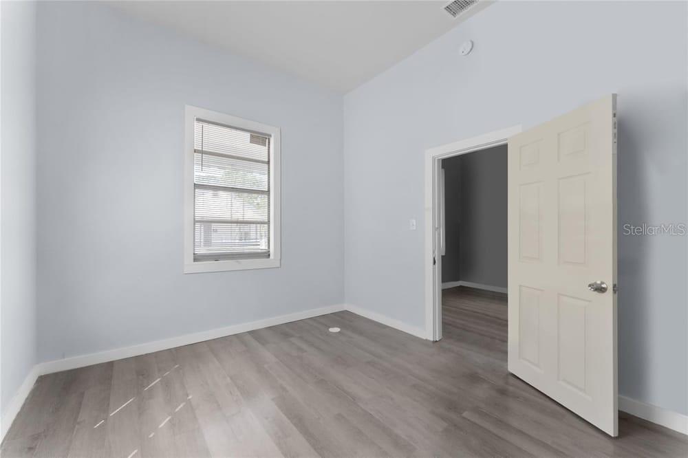 2320 West Walnut Street Tampa, FL 33607 - Photo 15 of 19 an empty room with wooden floor and window
