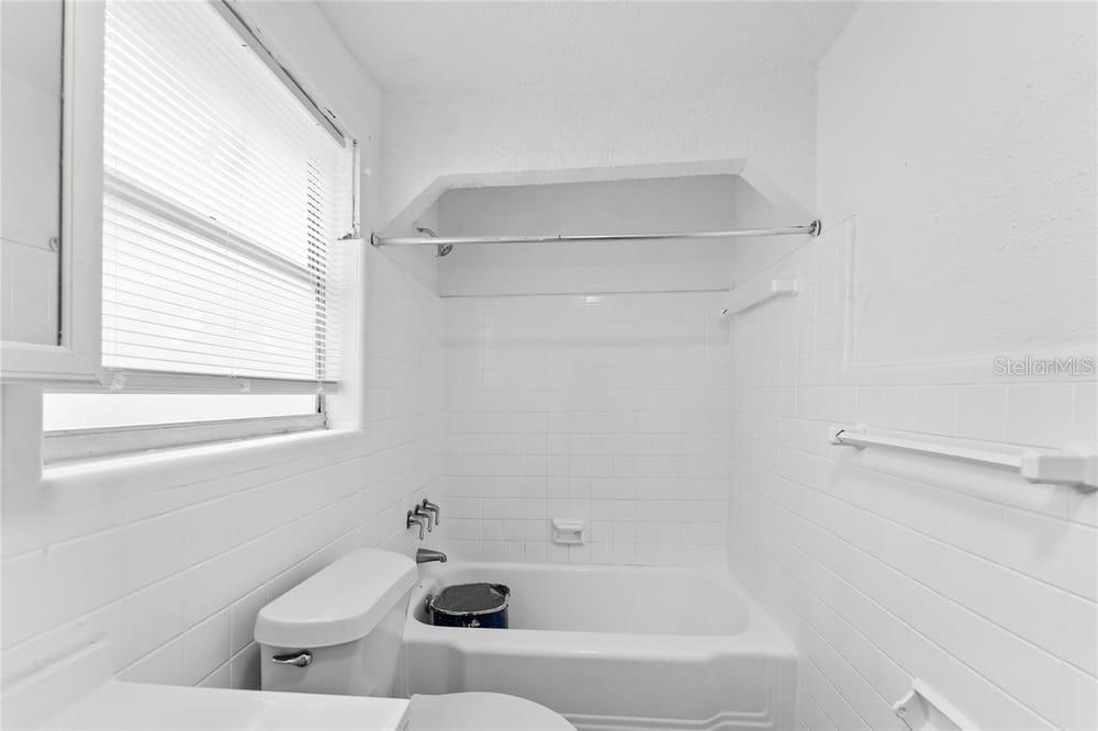 2320 West Walnut Street Tampa, FL 33607 - Photo 18 of 19 a bathroom with a bathtub and window