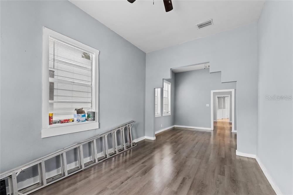 2320 West Walnut Street Tampa, FL 33607 - Photo 2 of 19 a view of an empty room with wooden floor and a window