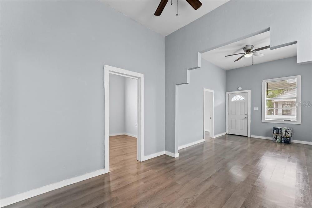 2320 West Walnut Street Tampa, FL 33607 - Photo 5 of 19 an empty room with wooden floor and windows