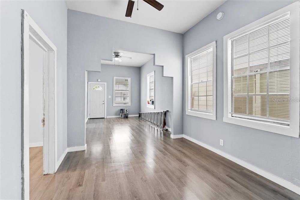 2320 West Walnut Street Tampa, FL 33607 - Photo 6 of 19 a view of an empty room with wooden floor and a window