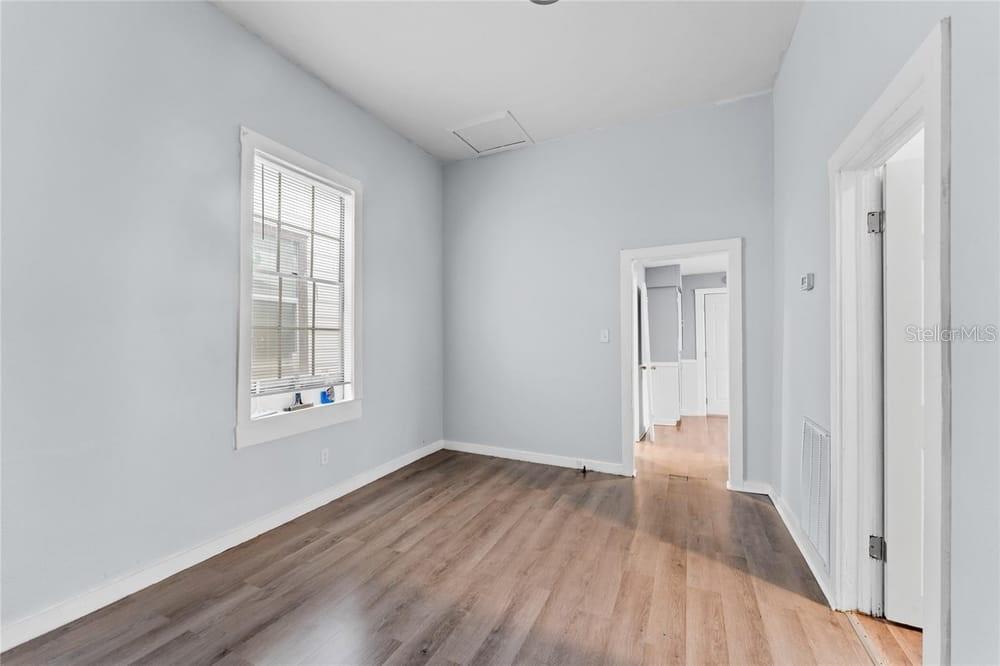 2320 West Walnut Street Tampa, FL 33607 - Photo 7 of 19 wooden floor in an empty room with a window