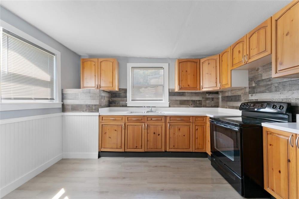 2320 West Walnut Street Tampa, FL 33607 - Photo 10 of 19 a kitchen with stainless steel appliances granite countertop a stove a sink and a granite counter tops