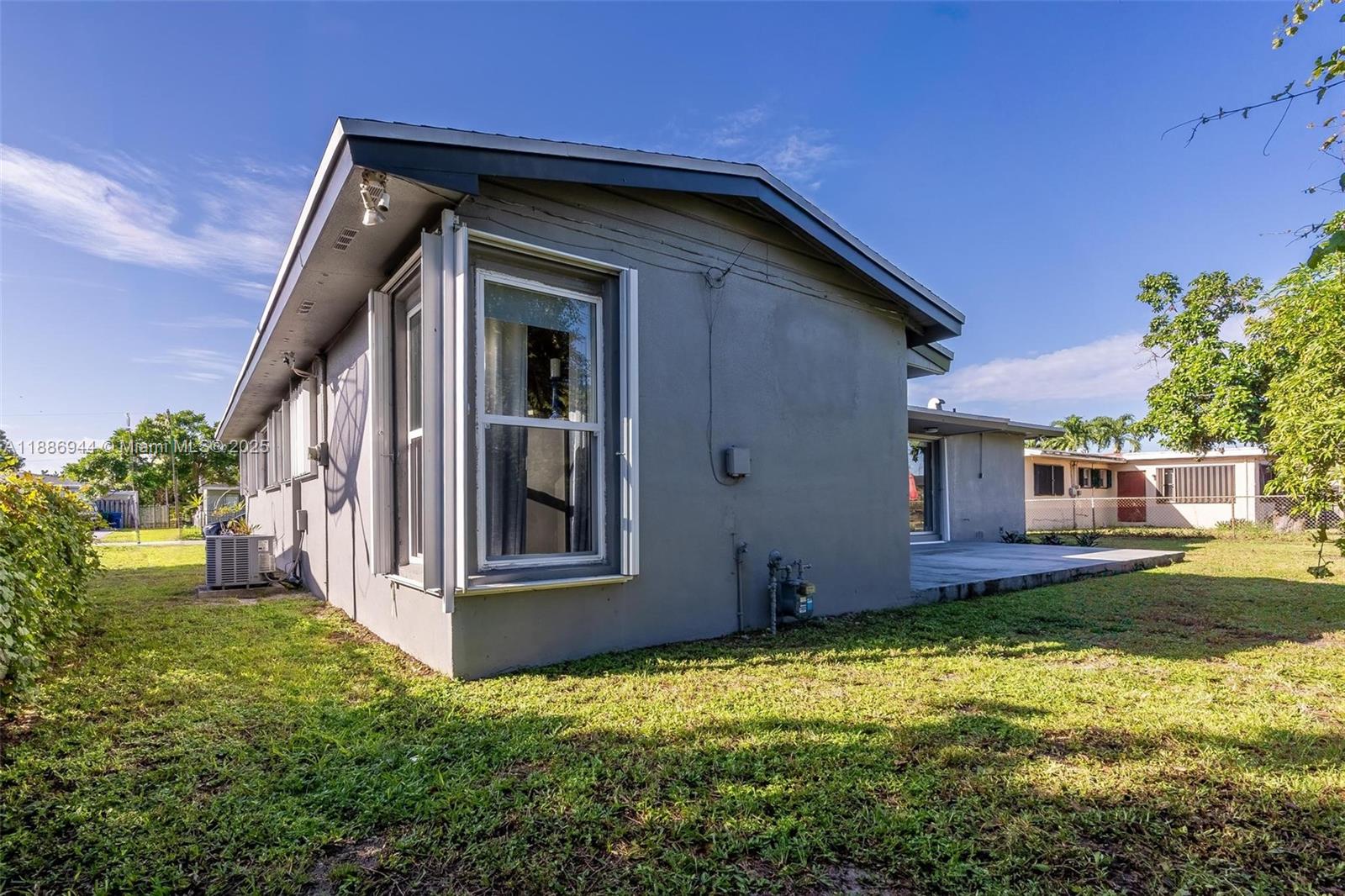 1465 Northwest 181st Street Miami Gardens, FL 33169 - Photo 13 of 15 a front view of a house with garden