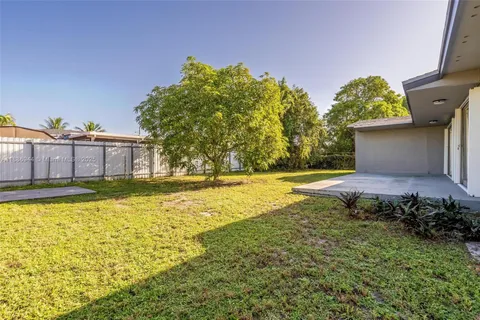 a view of a swimming pool with an outdoor seating and yard