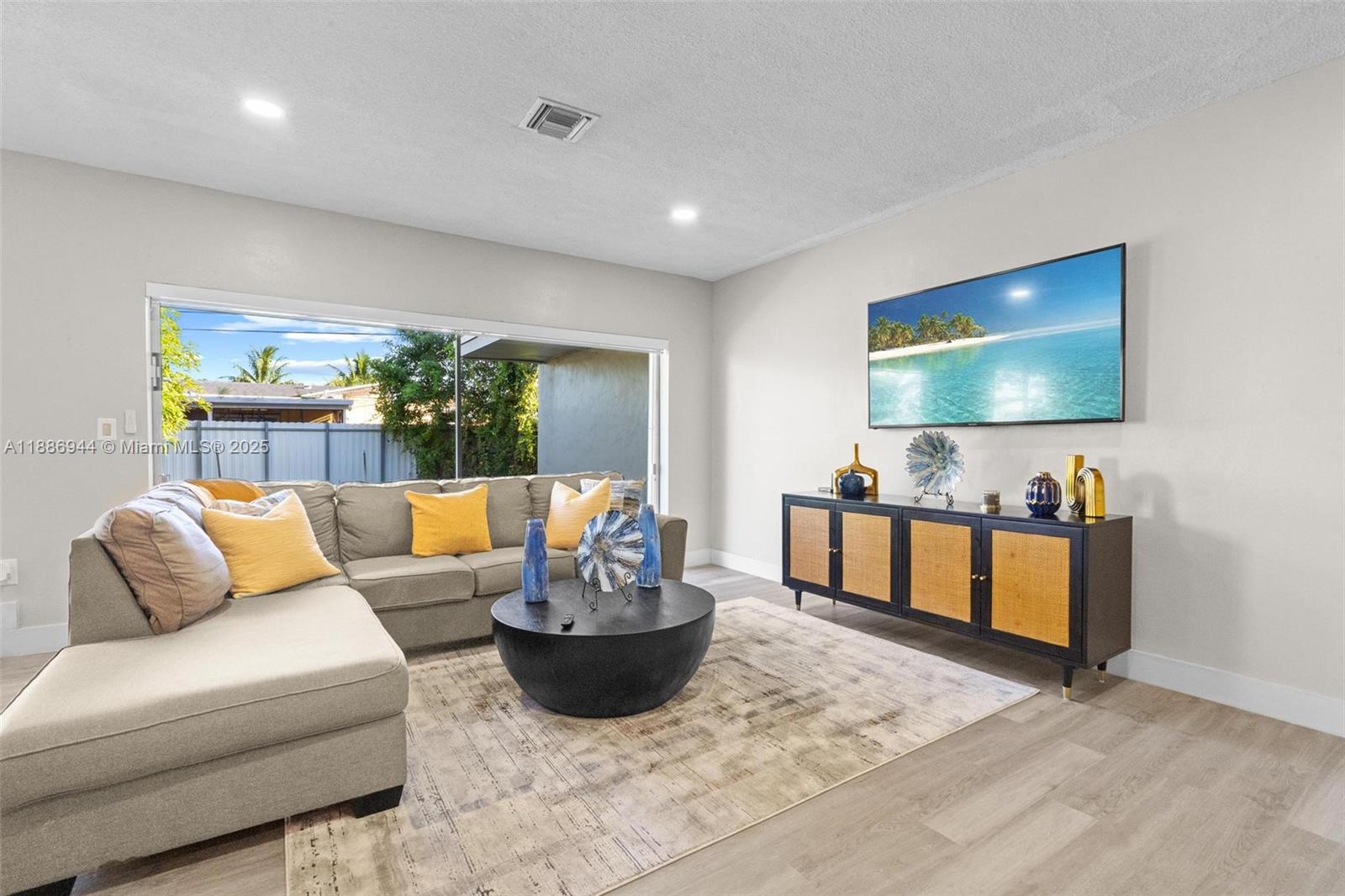 1465 Northwest 181st Street Miami Gardens, FL 33169 - Photo 3 of 15 a living room with furniture and a flat screen tv