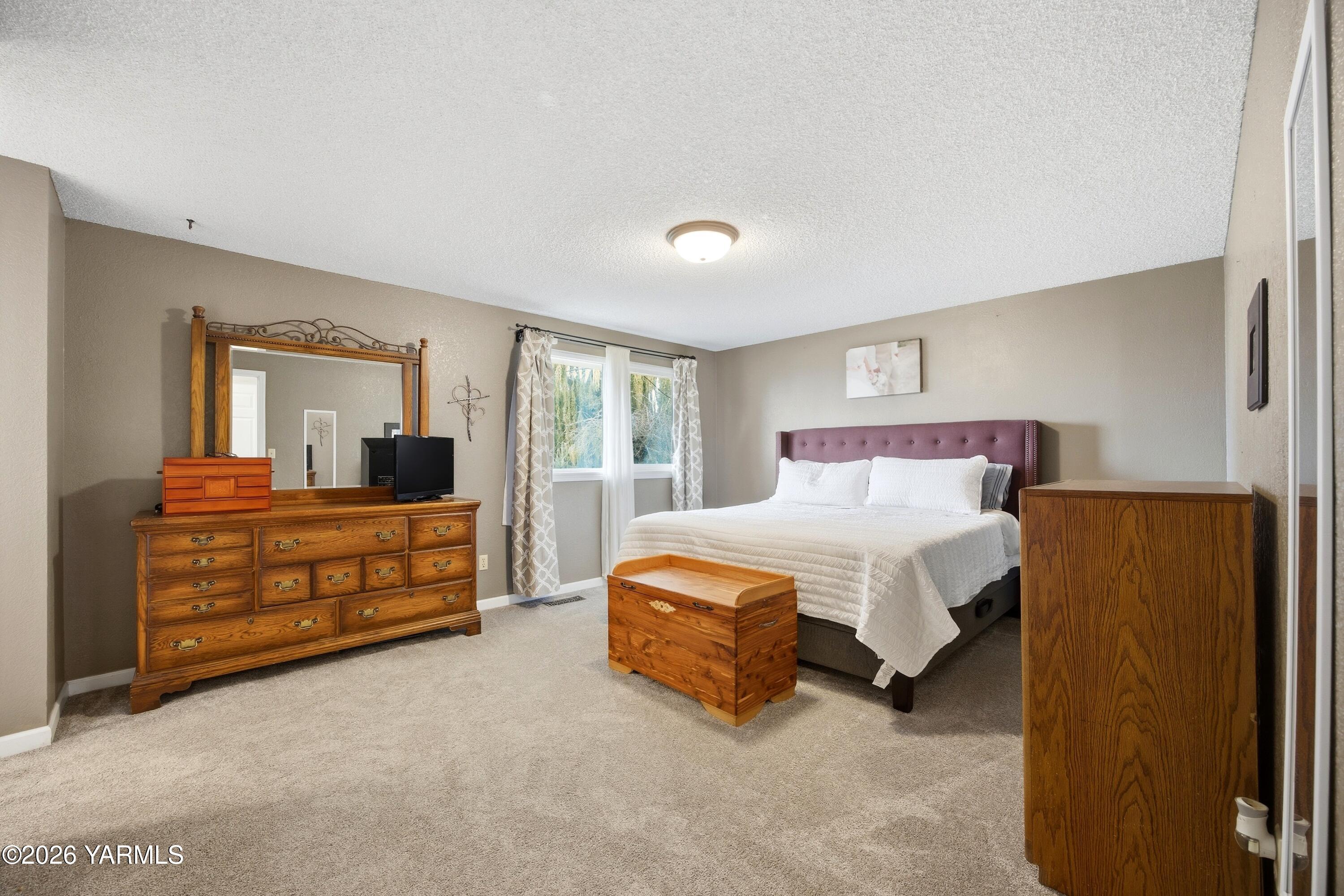 1681 Olmstead Road Grandview, WA 98930 - Photo 1 of 49 a bedroom with a bed and a dresser