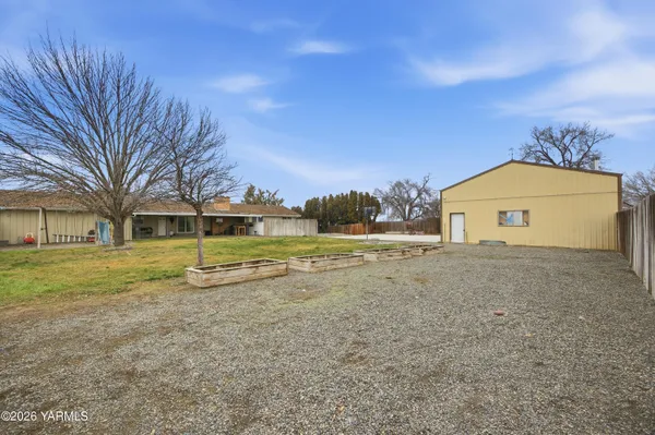 a view of a house with a yard patio and swimming pool