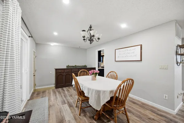 a bedroom with a bed and painting on the wall