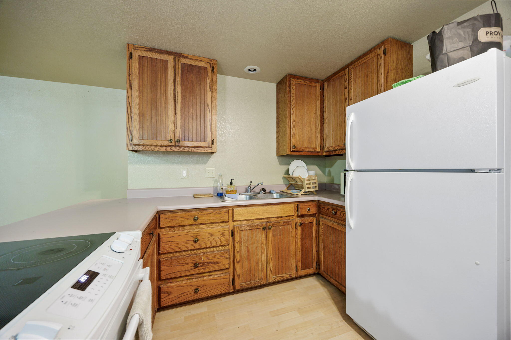 75 Wimer Street Ashland, OR 97520 - Photo 39 of 44 a kitchen with a refrigerator sink and cabinets