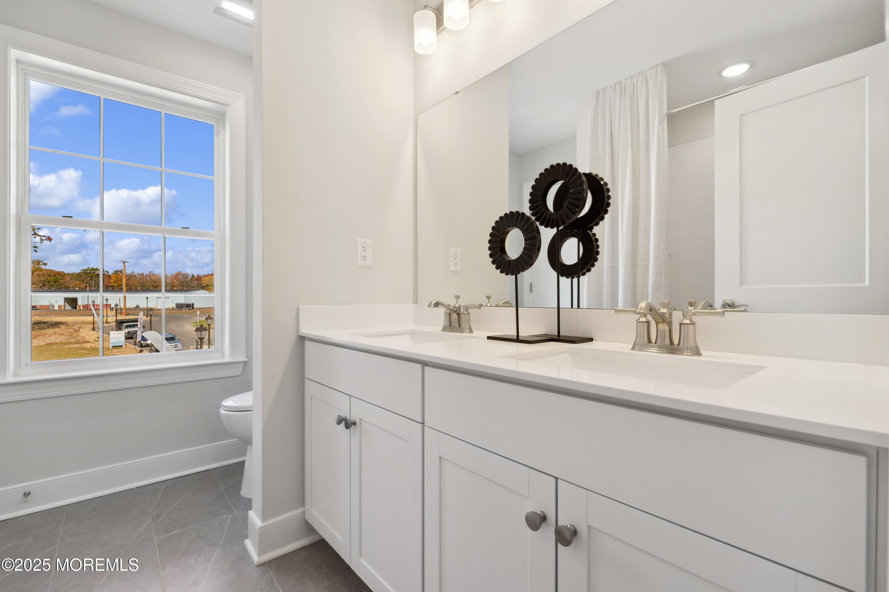 3043 Quail Ridge Boulevard Farmingdale, NJ 07727 - Photo 27 of 36 a bathroom with a sink and a mirror