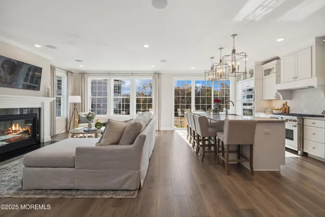 a living room with furniture a dining table and a fireplace