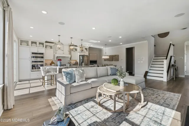a living room with furniture kitchen view and a table