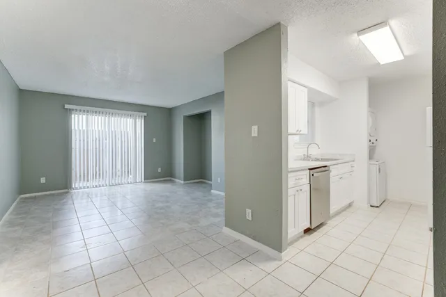 a view of a kitchen with white cabinets