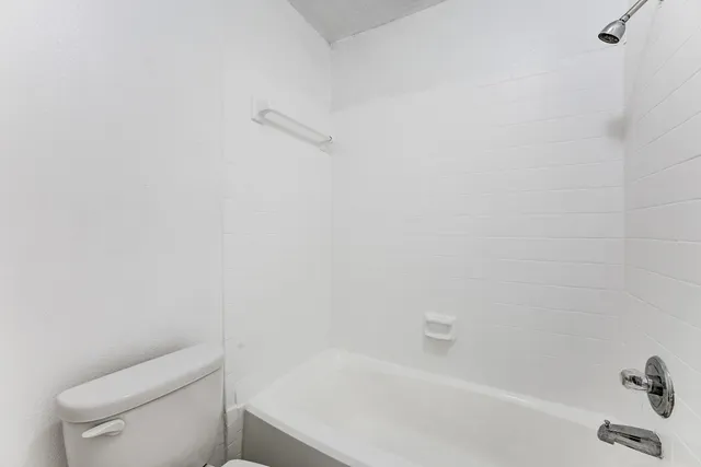a bathroom with a bathtub and toilet