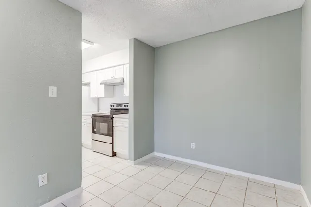 a view of a kitchen with white cabinets
