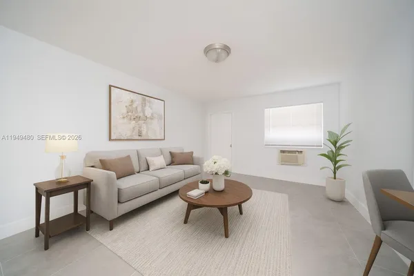 a living room with furniture a potted plant and a window